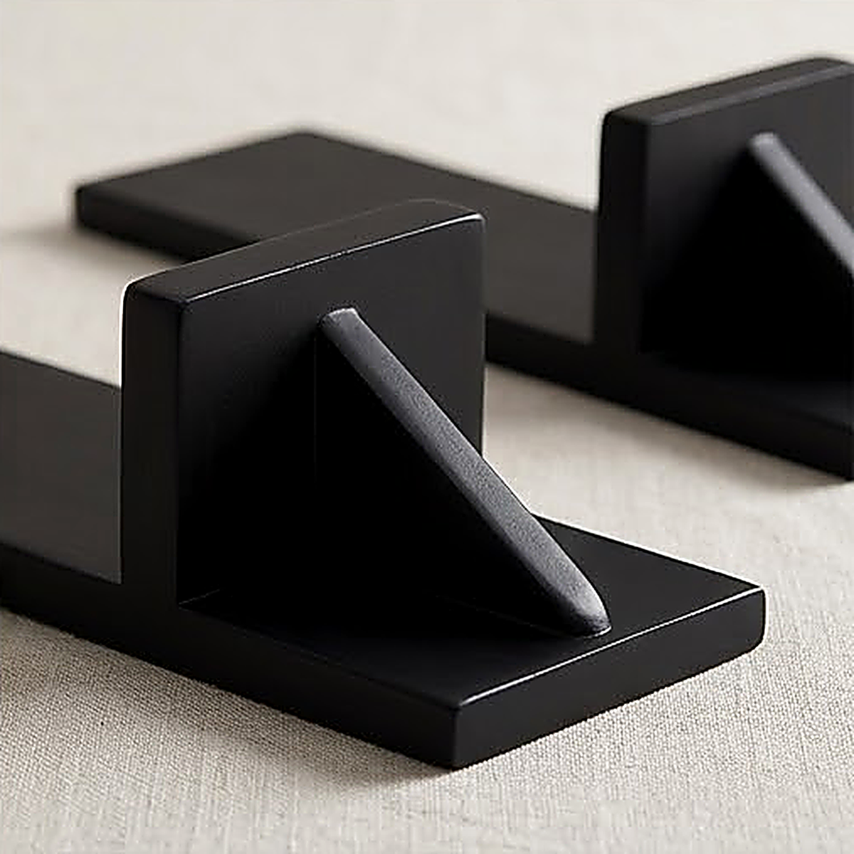 Close view of the black sconce shelf and its support bracket, showing the flat matte finish