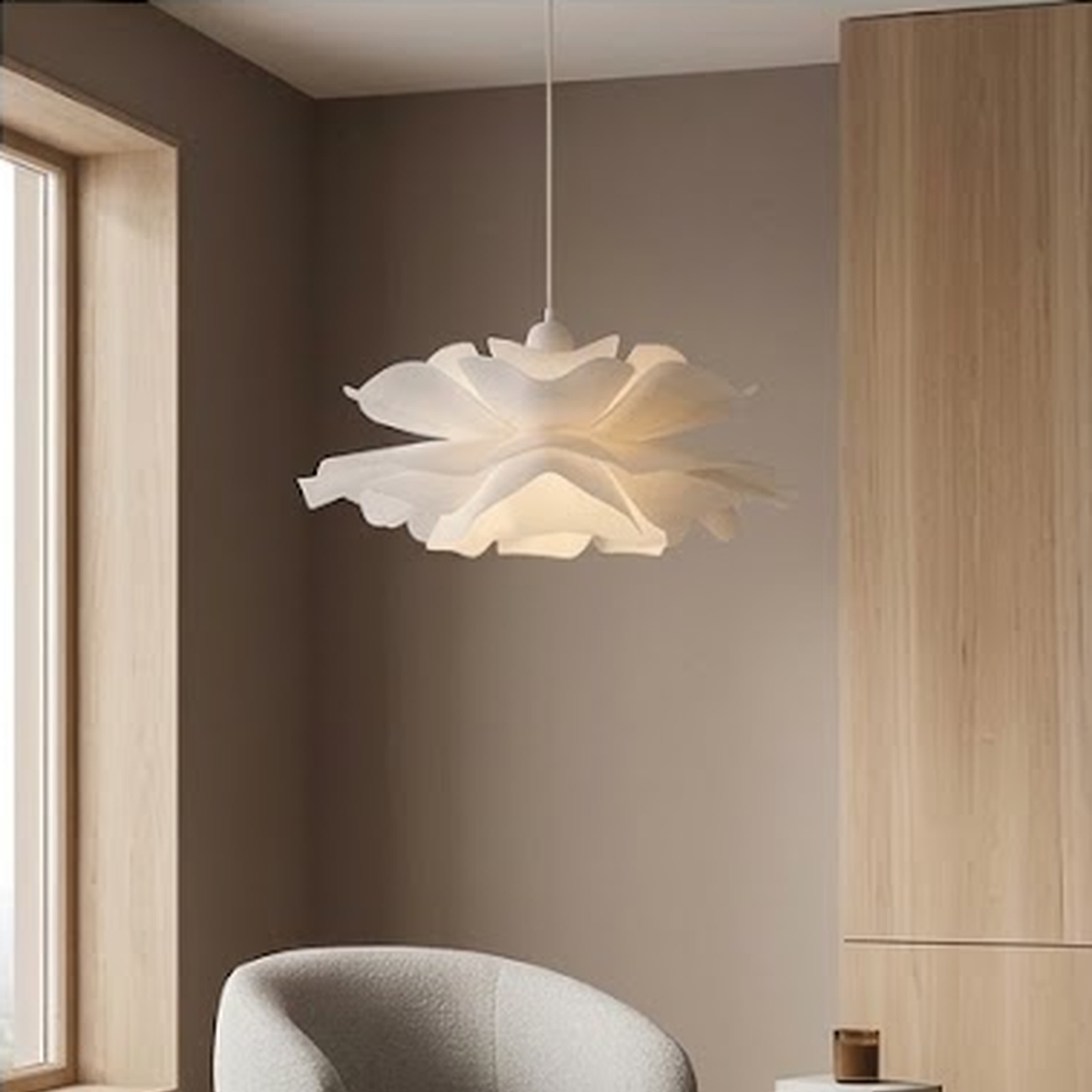 Petal pendant lit in a corner with a boucle armchair and oak cabinetry