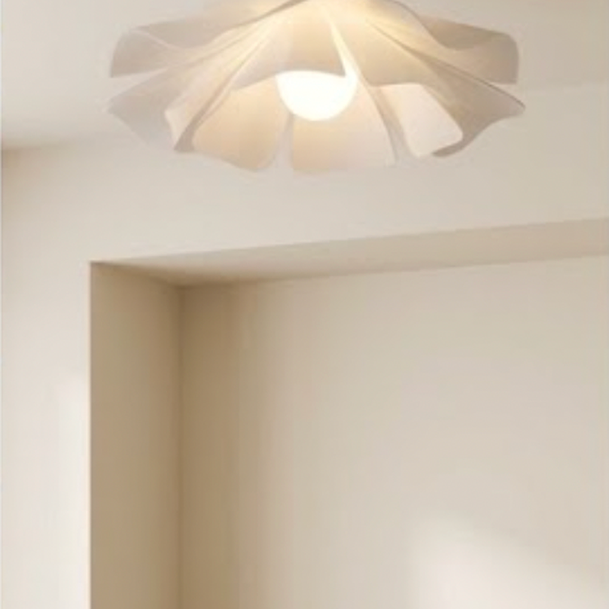 Flush mount petal ceiling light above an oak desk nook with a vase and laptop