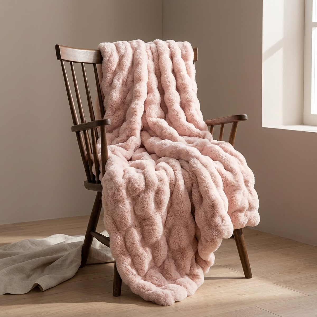 The pink throw over a dark walnut chair, showing the ruched pile in raking light