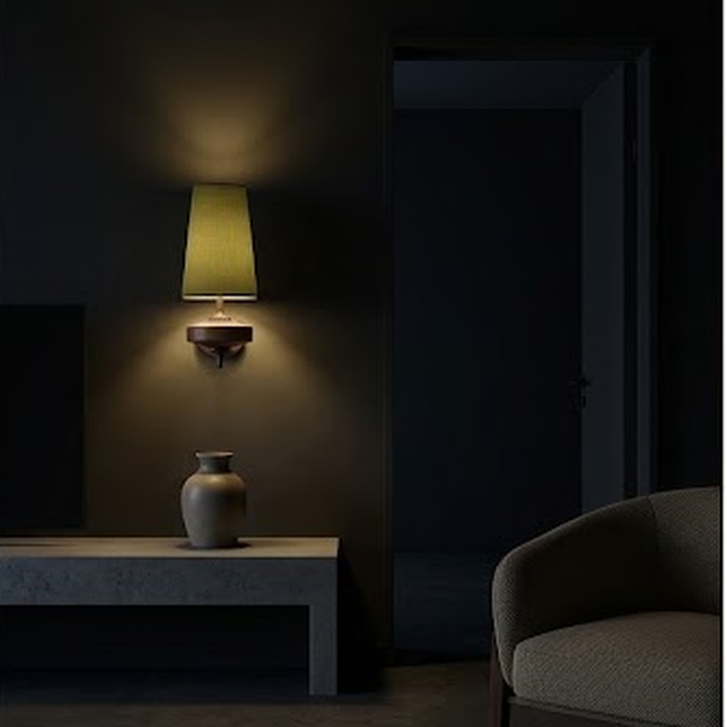 Olive sconce lit at night above a console table in a dark room