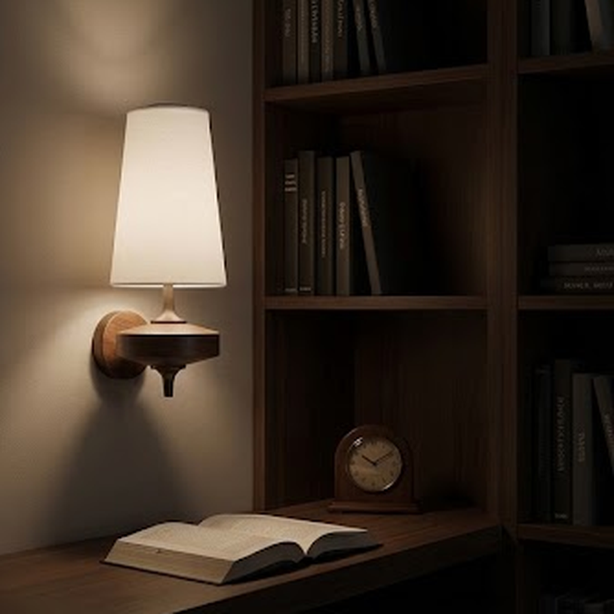 White sconce lit at night beside a walnut bookshelf and a reading chair