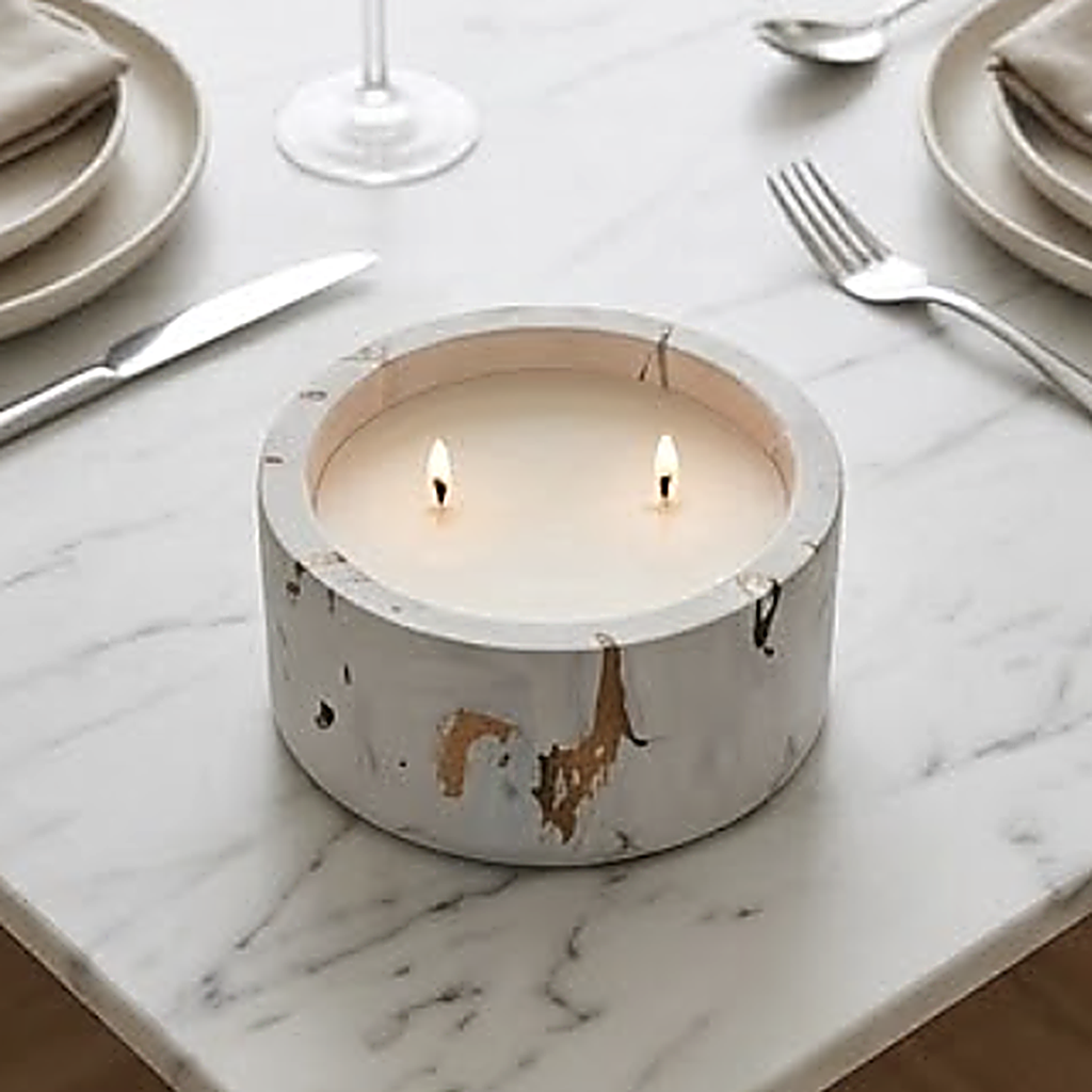 The white and gold marble finish on a marble dining table between place settings. Shown poured; sold as an empty vessel