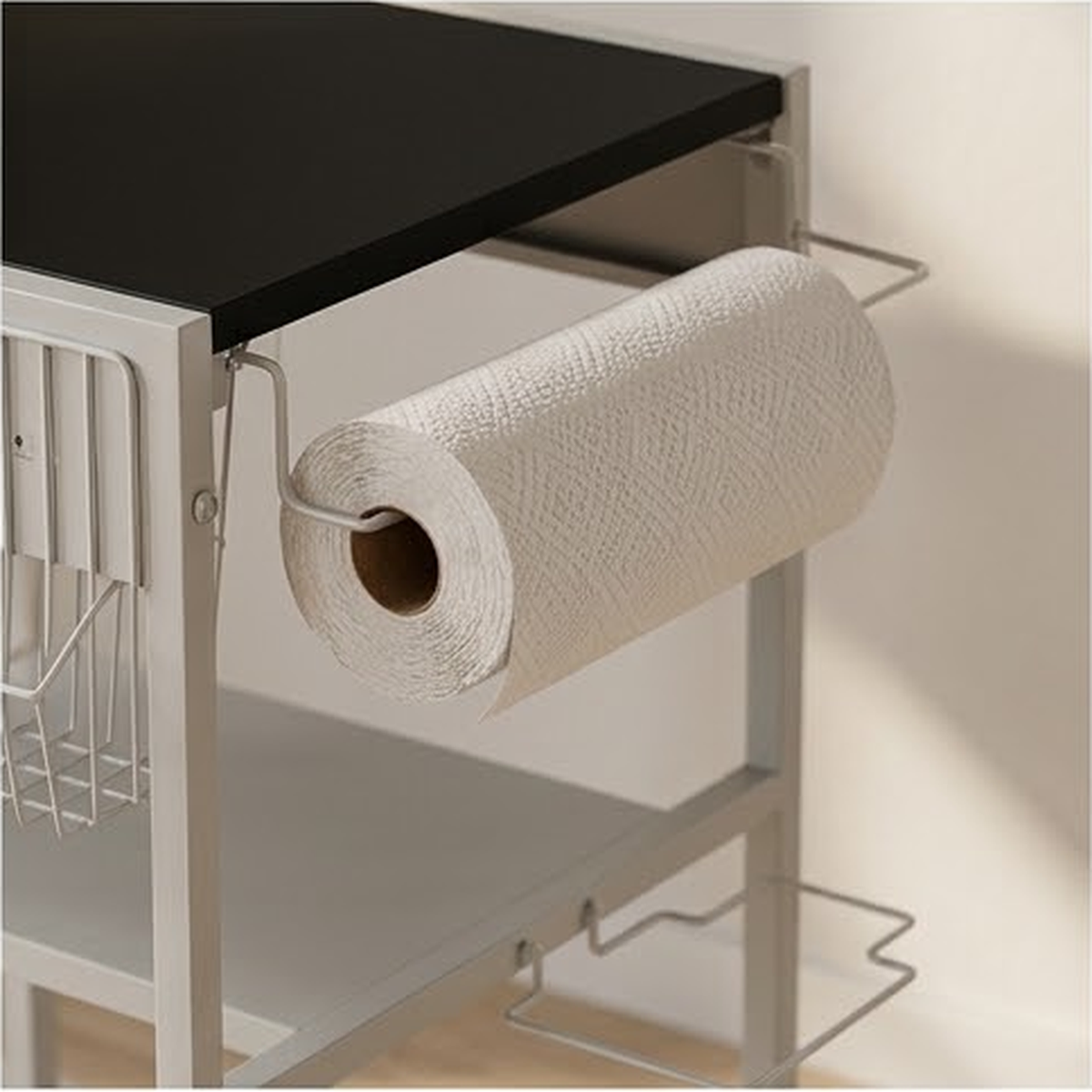 Close view of the side mounted paper towel holder and the hook rail under the work surface