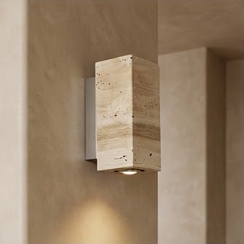Square travertine sconce on a plaster wall washing light up and down