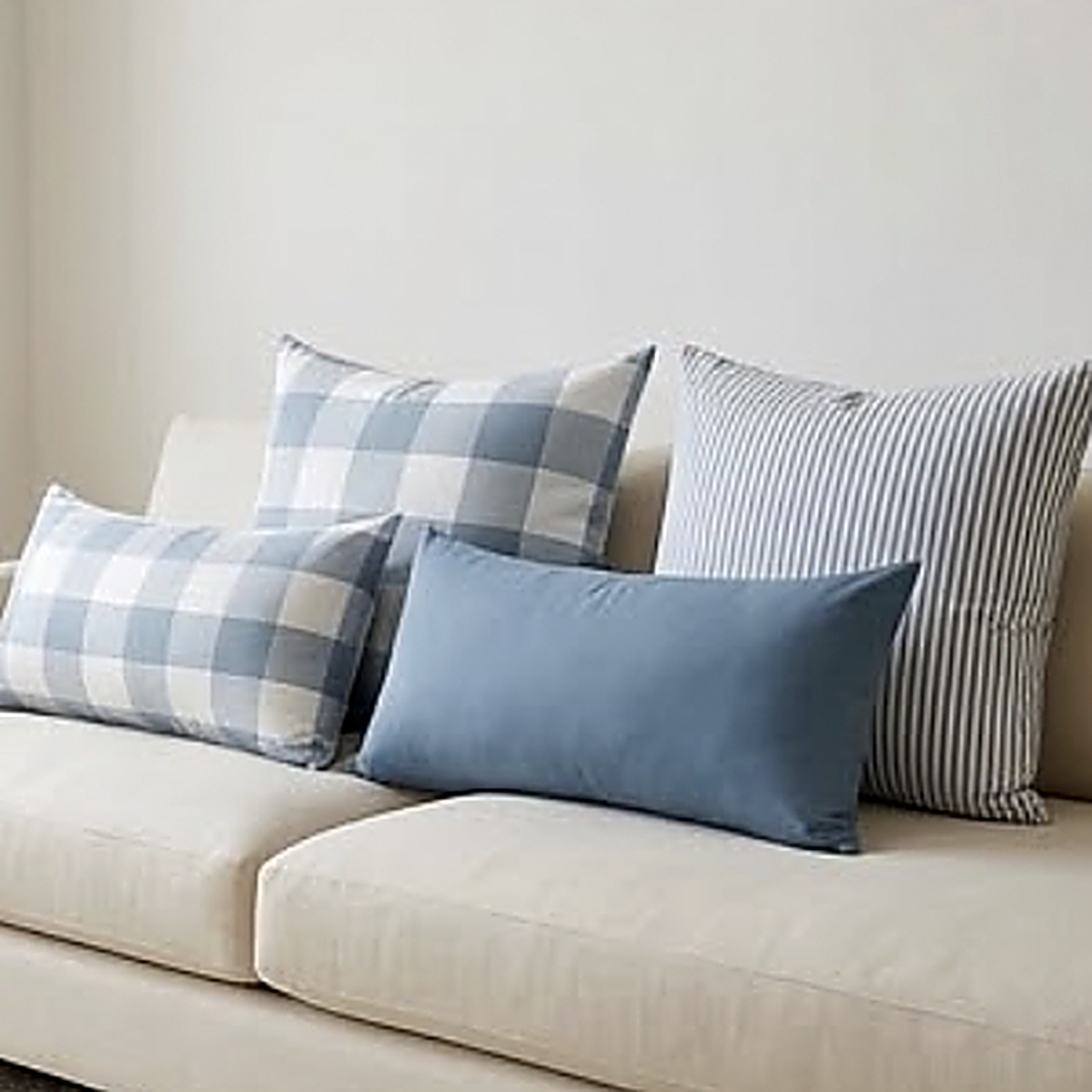 All four patterns together on a cream sofa, showing both the 45 cm square and the 30 x 50 cm lumbar shapes. Each is sold singly