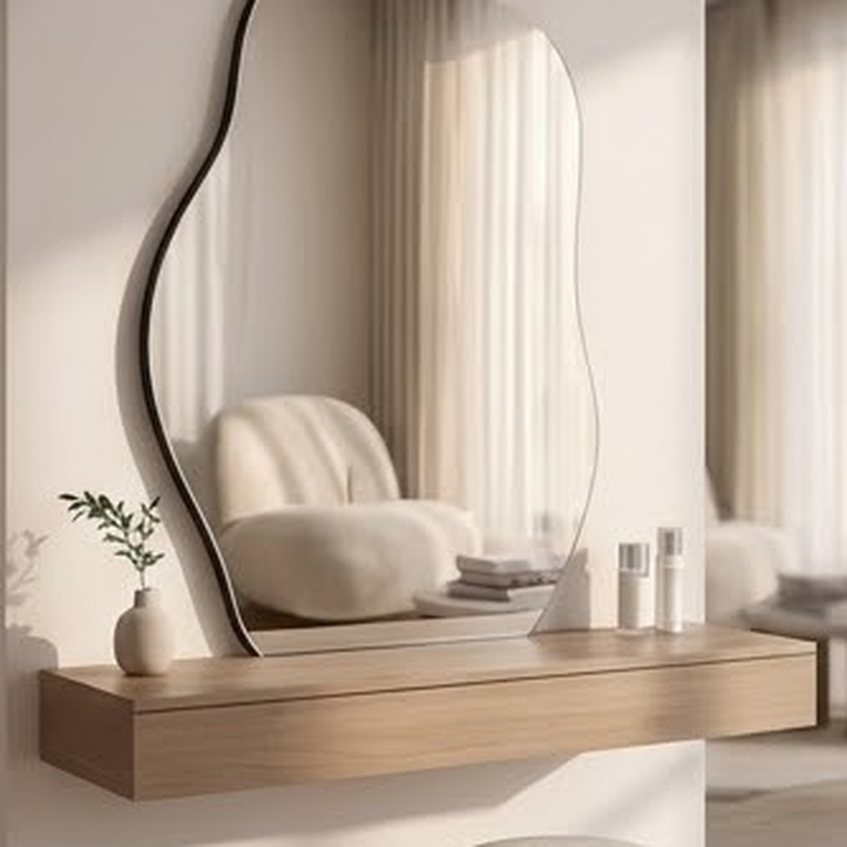 Irregular wall mirror above a floating oak vanity shelf in a soft neutral bathroom