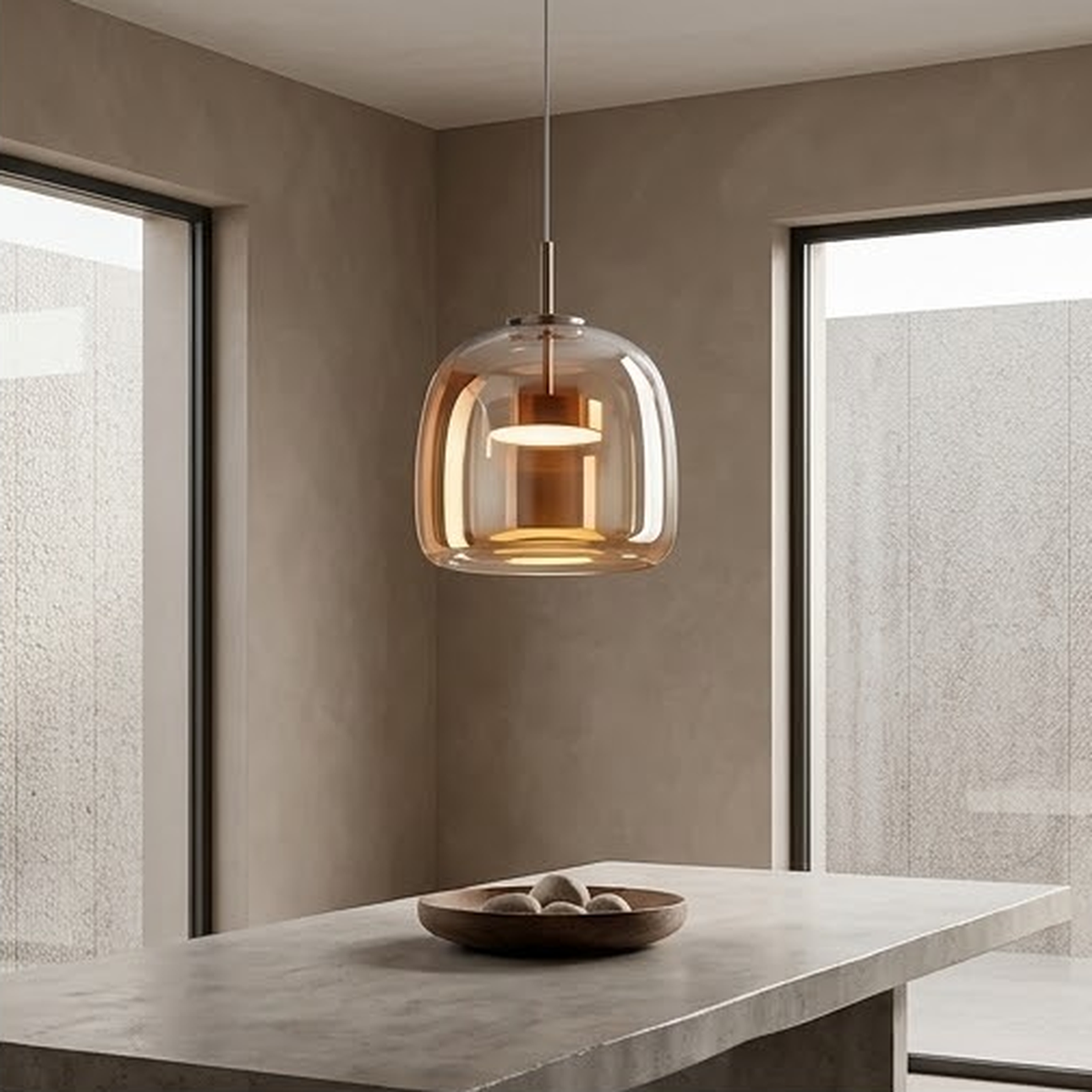 Single amber glass pendant lit above a concrete kitchen island
