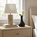 Matte black ceramic gourd vase, 10.3 cm, holding a single white rose on a bedroom nightstand