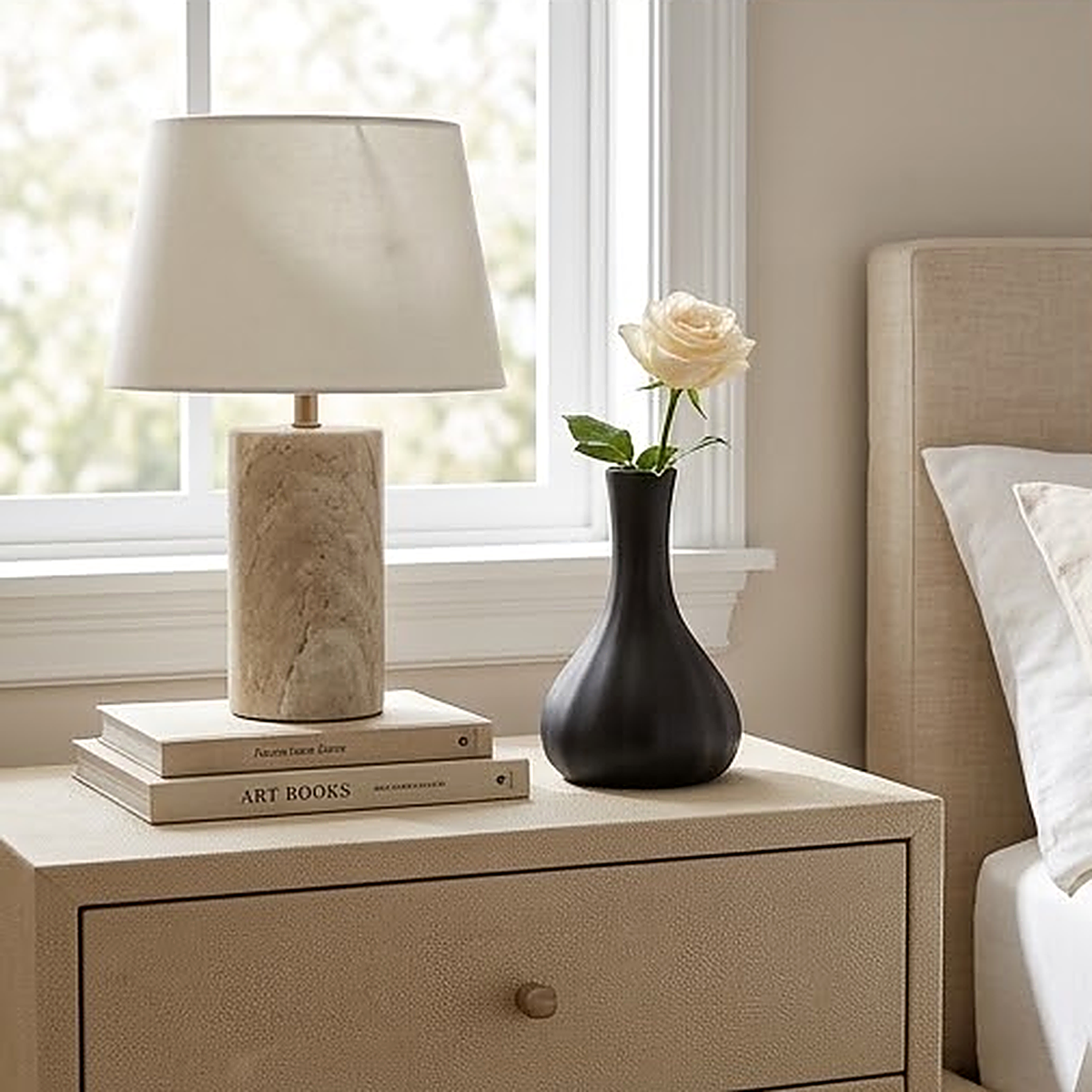 Matte black ceramic gourd vase, 10.3 cm, holding a single white rose on a bedroom nightstand